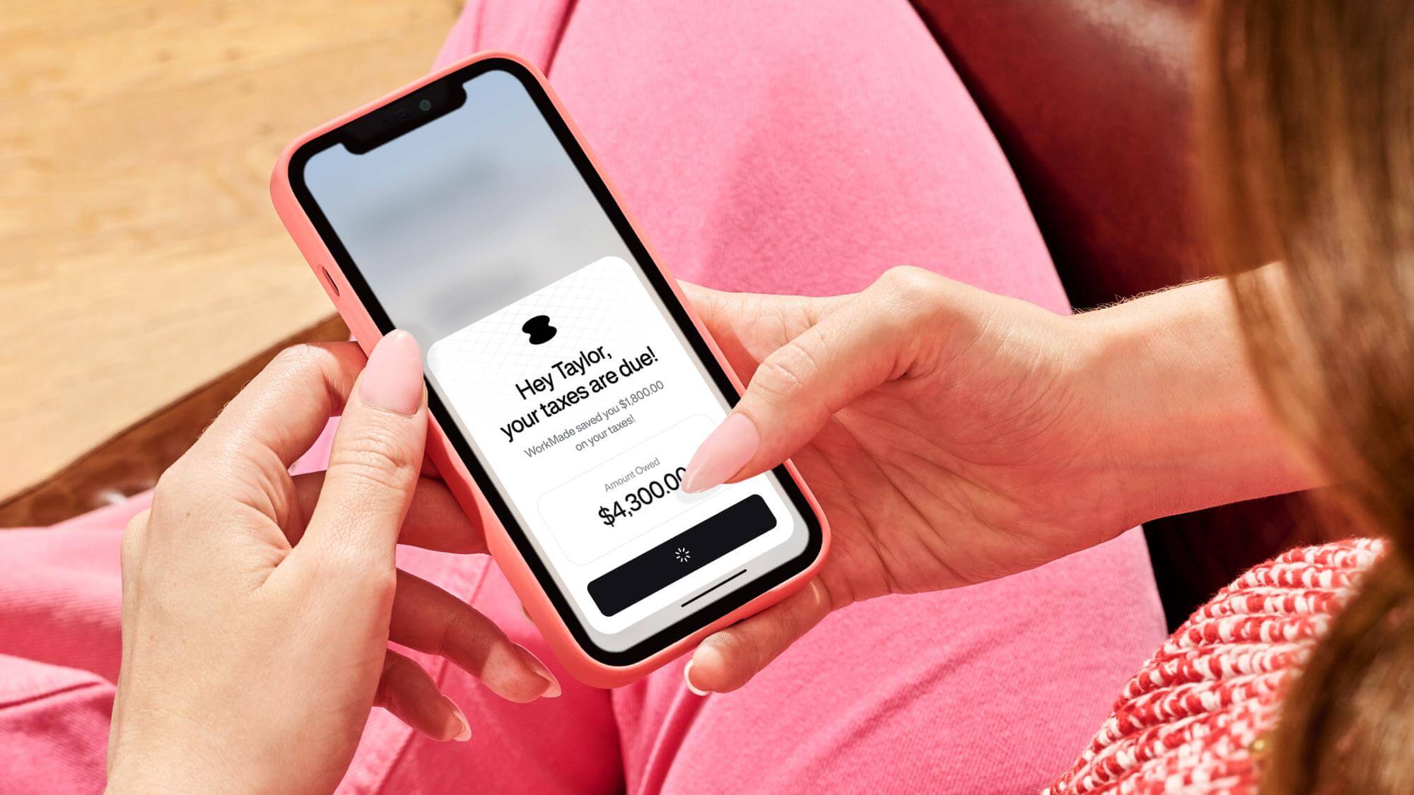 Person holding a phone with a tax notification from the WorkMade app